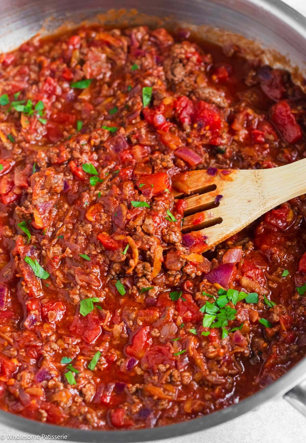 Spaghetti Bolognese sauce simmering in skillet.