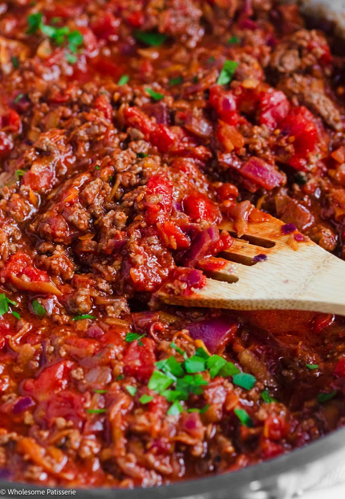 Spaghetti Bolognese sauce simmering in skillet.